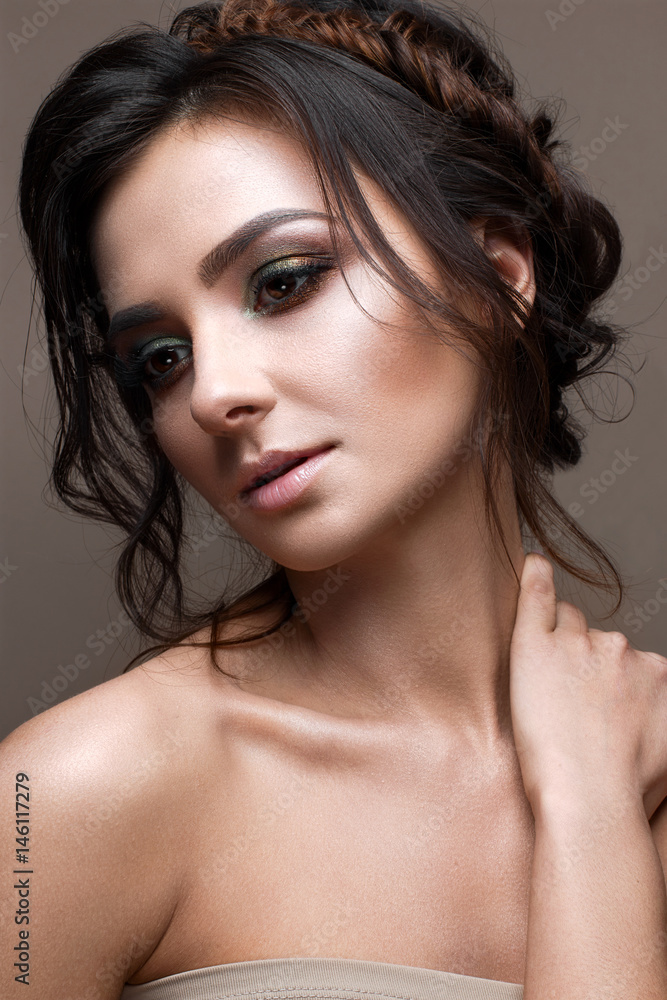 A young girl with bright creative makeup and evening hairstyle. Beautiful model with perfect skin. Beauty of the face. Photo is taken in the studio. A young girl with bright creative makeup and evening hairstyle. Beautiful model with perfect skin. Beauty of the face. Photo is taken in the studio.