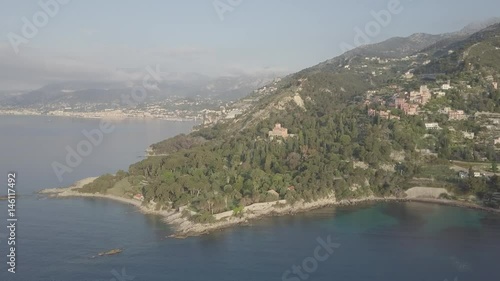 Flight over the mediterranean coastline on the border Italy France. Capo Mortola, Grimaldi (Ventimiglia), Italy, Europe. Aerial panoramic view 4K, UHD native log movie. photo