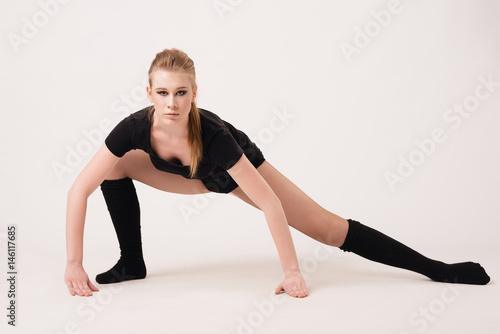 Plasticity. A girl performs an exercise on flexibility.