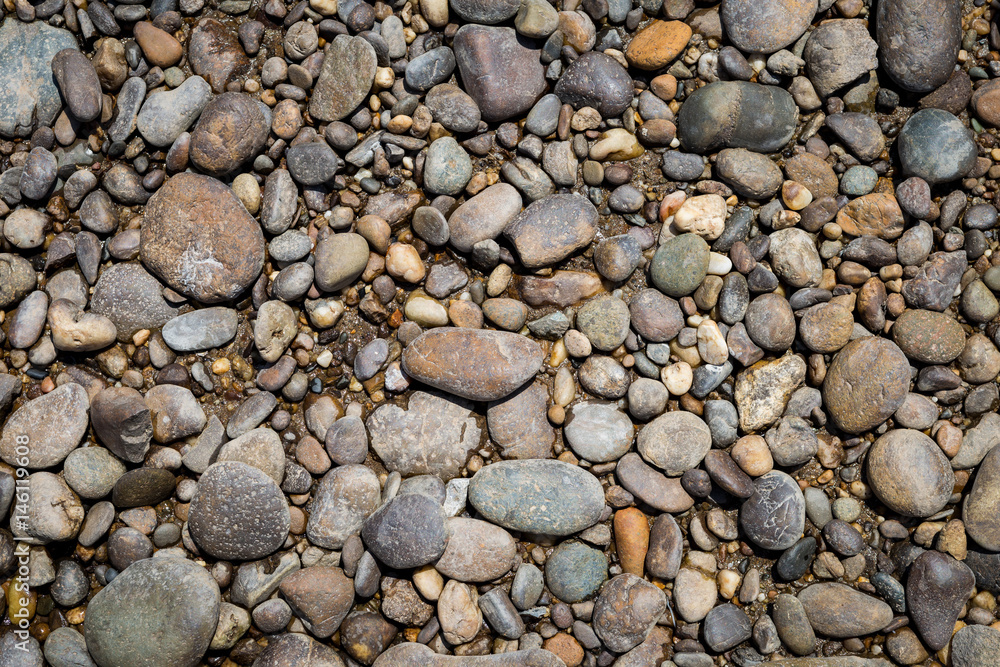 Natural background of round stone on the beach, outdoor day light Natural background of round stone on the beach, outdoor day light