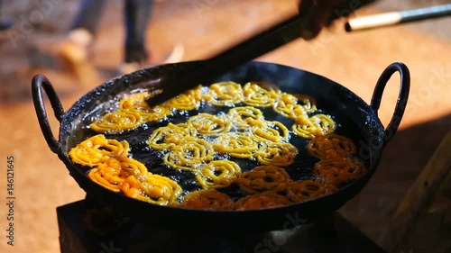 Man cooking Indian street sweets Jalebi. A sweet Indian Food in Goa.