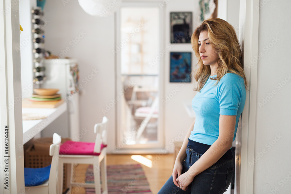 Beautiful blonde woman posing in kitchen at home Beautiful blonde woman posing in kitchen at home