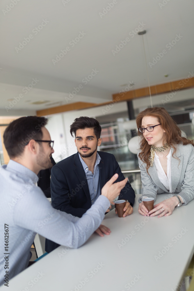 Business colleagues collaborating and discussing project plans Business colleagues collaborating and discussing project plans