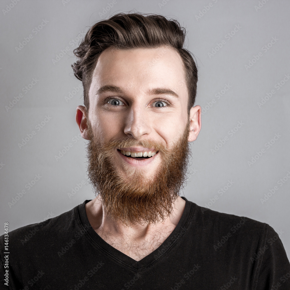 Obraz premium Exited young man isolated on gray background