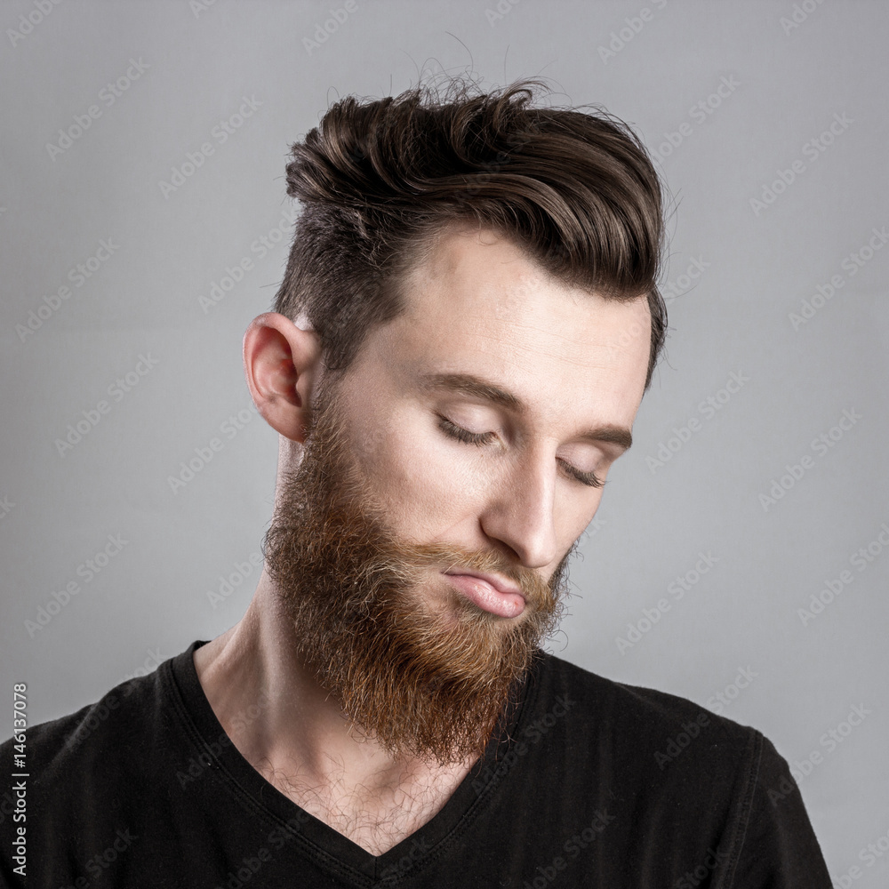 Fototapeta premium Moody and sad young man isolated on gray backround
