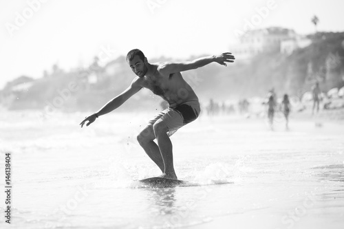 Skimboarder in beach