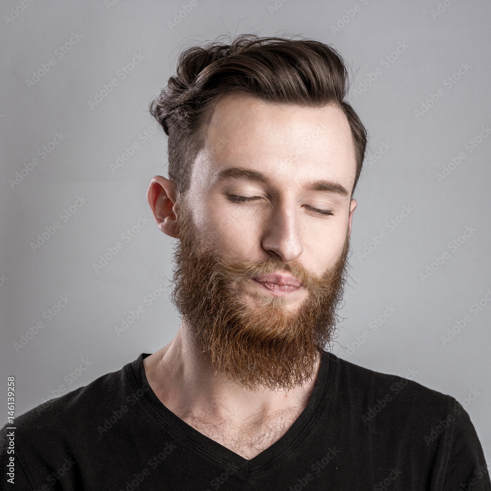 Obraz premium Tired sleepy young man isolated on gray background
