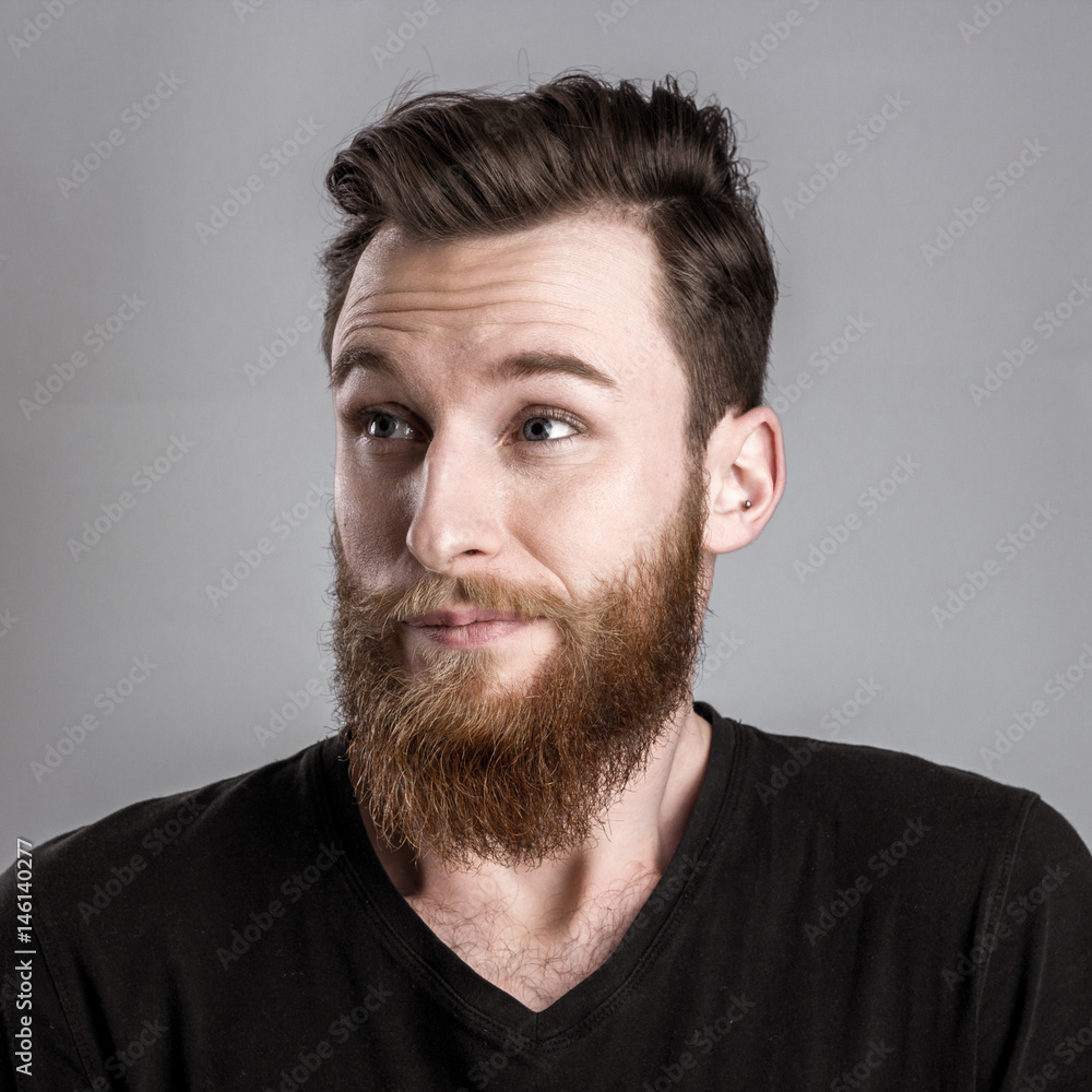 Unconfident and worried young man isolated on gray background Unconfident and worried young man isolated on gray background
