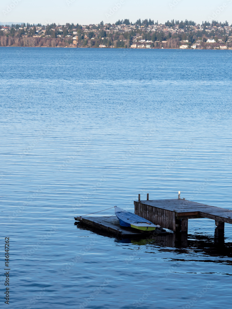 solitary dinghy on wooden dock, copy space solitary dinghy on wooden dock, copy space