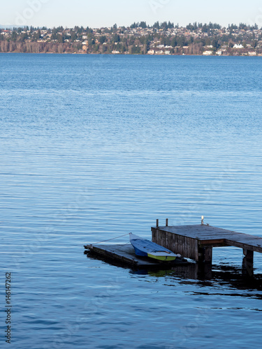 solitary dinghy on wooden dock, copy space