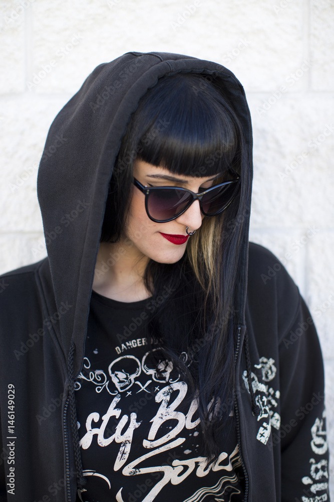 Portrait of a young beautiful woman in a urban background wearing black clothing Portrait of a young beautiful woman in a urban background wearing black clothing