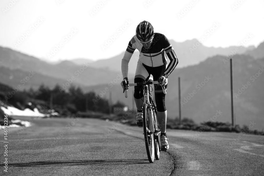 Fototapeta premium Cyclist man riding mountain bike on a mountain road