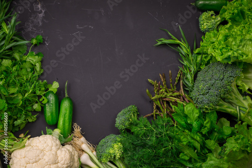 Fresh spring colorful vegetables on black chalkboard