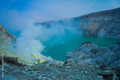 KAWEH IJEN, INDONESIA: Nice overview of sulfur mine with miners working next to volcanic crater lake, spectacular nature