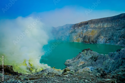 KAWEH IJEN, INDONESIA: Nice overview of sulfur mine with miners working next to volcanic crater lake, spectacular nature