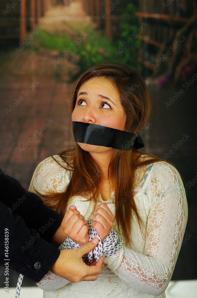 Terrified young girl kidnapped and bonded foto de Stock Adobe Stock
