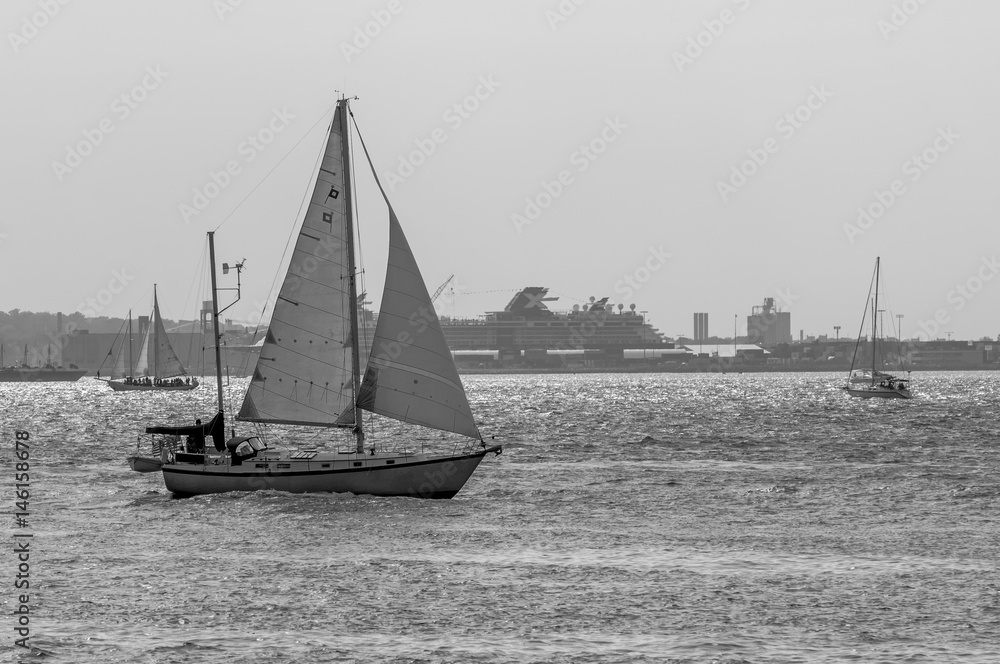 Sailboats in NYC harbor with surf highlights black and white