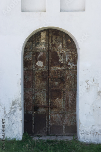 ancient rusty door entrance to old castle © PabloStock