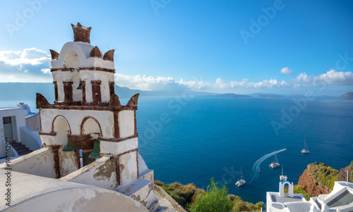 Bell tower of an orthodox church at Santorini with view at the Caldera, Greece. Honeymoon summer aegean cycladic background.