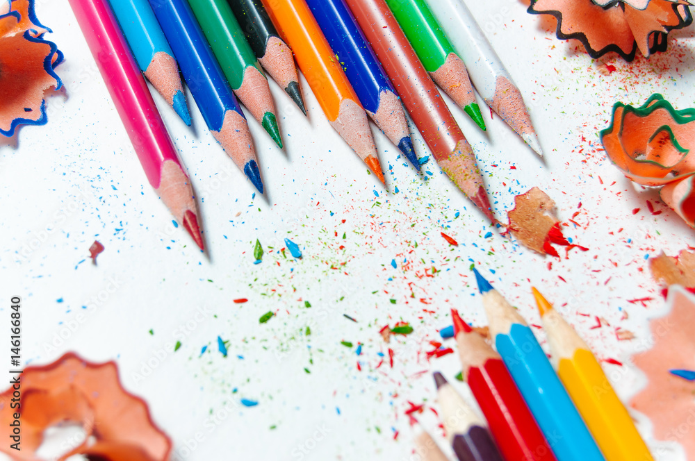 Many different colored pencils on paper background Many different colored pencils on paper background