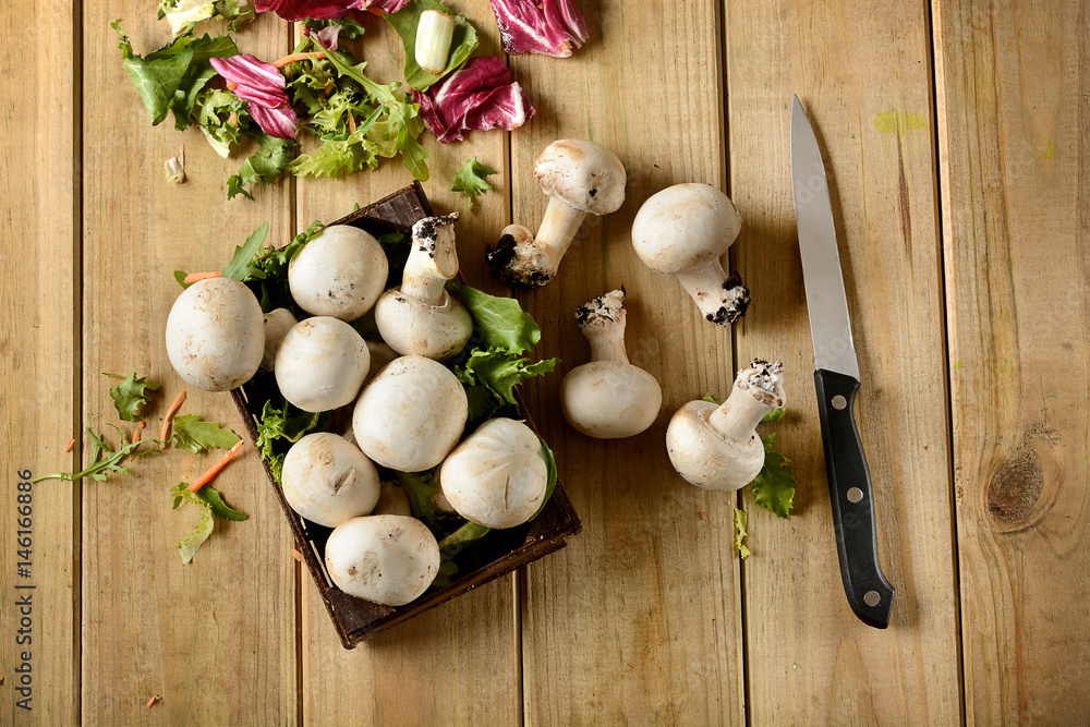 Champignon mushrooms on wooden table