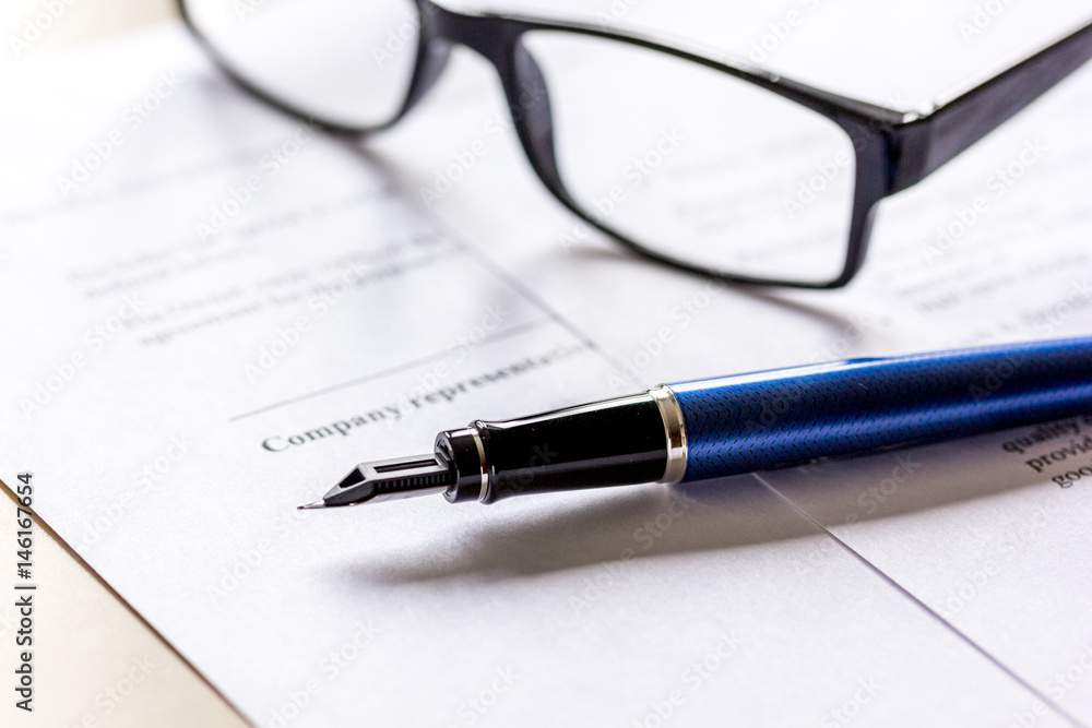 workspace with document, glasses and pen for sign for businessman day workspace with document, glasses and pen for sign for businessman day