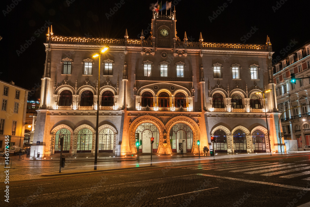 Lisbon train station building illuminated with long exposure car light trails