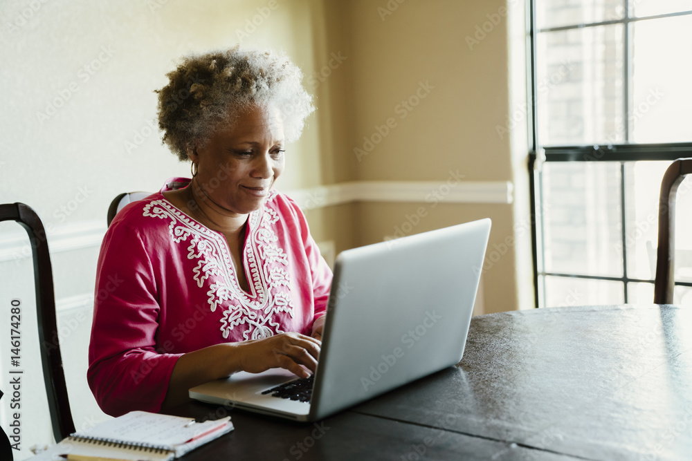 Black woman using laptop at table Black woman using laptop at table