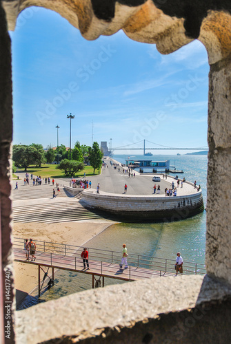 Lisbon coastline and cable bridge viewed through Belem tower portal