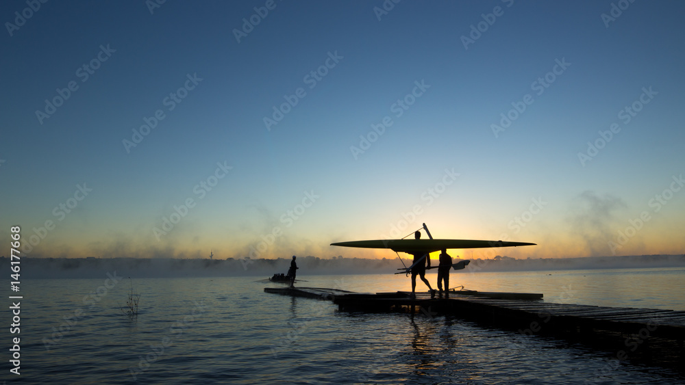Rower at sunrise with a fog in the background