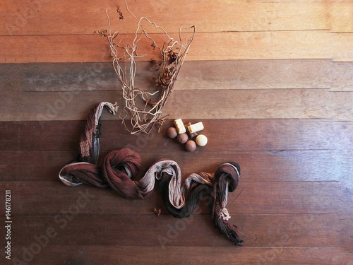 Love written with chocolate gradient fabric scarf chocolate bonbons and vine branches on wooden base seen from above with natural light. photo