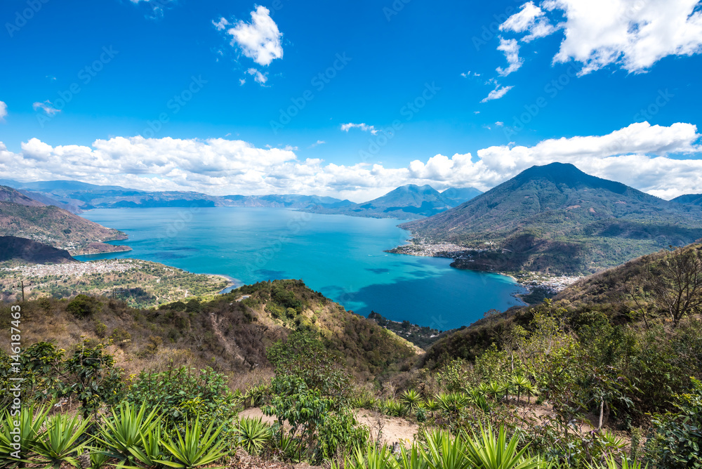 Panorama view to the lake Atitlan with volcanos - small villages San Pedro, San Marcos, San Juan and Panajachel at lake Atitlan in the highland of Guatemala