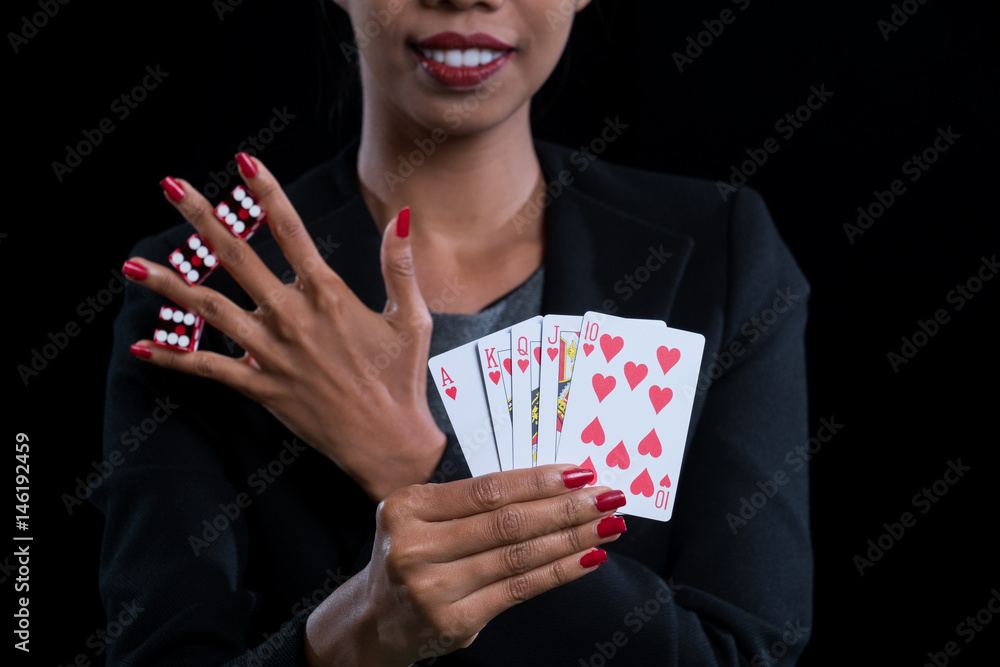 close up at hand clamp red dices between fingers and holding Hearts Suit Straight Flush close up at hand clamp red dices between fingers and holding Hearts Suit Straight Flush