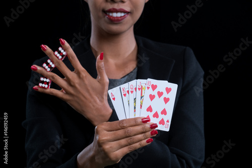 close up at hand clamp red dices between fingers and holding Hearts Suit Straight Flush