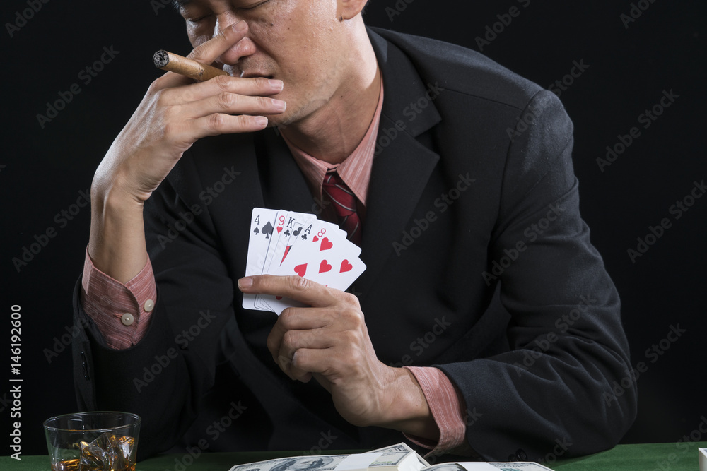 The gambler is smoking for stress relief when he defeat in poker game The gambler is smoking for stress relief when he defeat in poker game