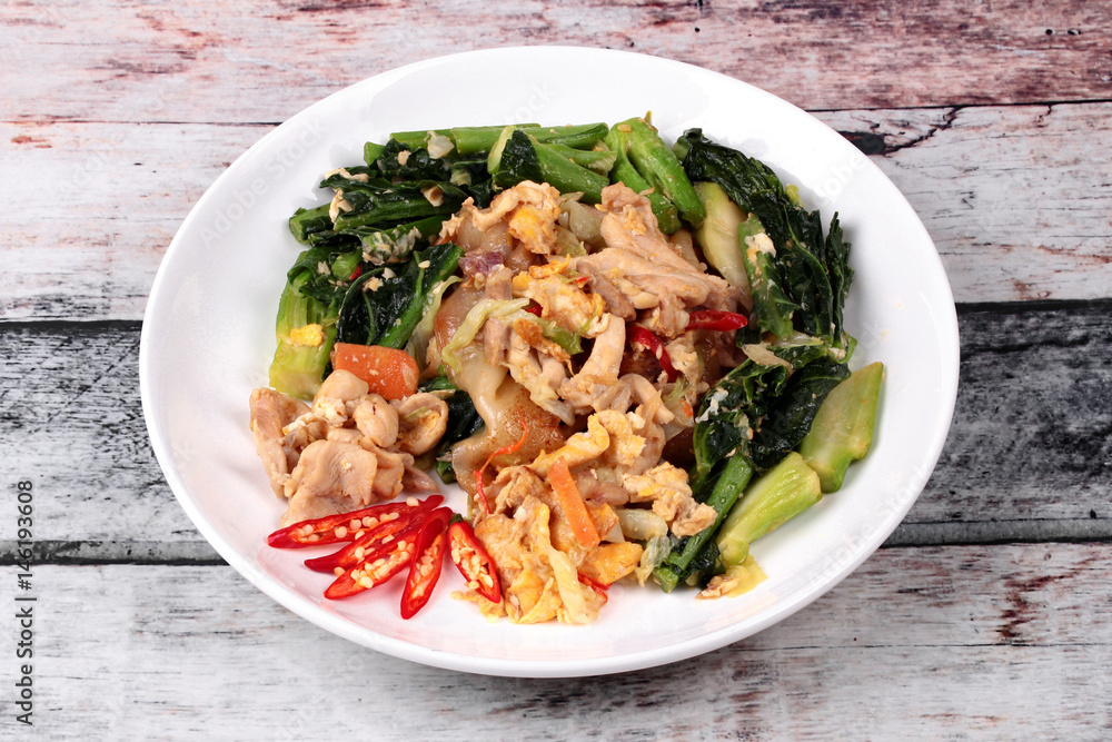 Fried big noodle with chicken and vegetables. Fried big noodle with chicken and vegetables.