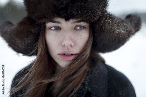 Serious Caucasian woman wearing fur hat and coat in winter