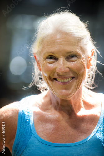 Portrait of smiling older woman sweating,  photo