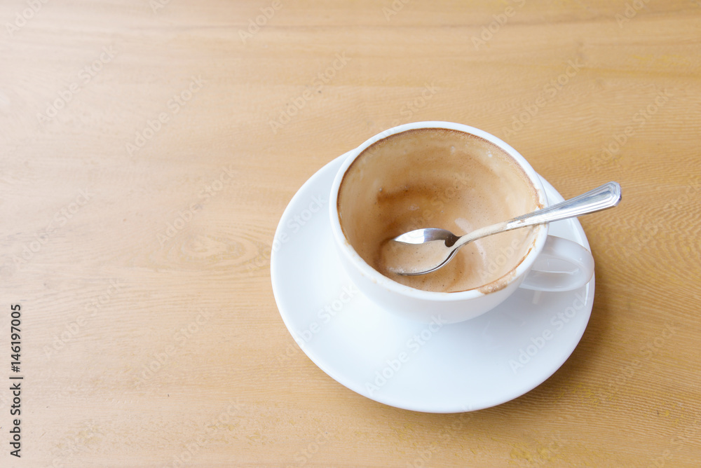 Fototapeta premium Empty coffee cup after drink on wood table