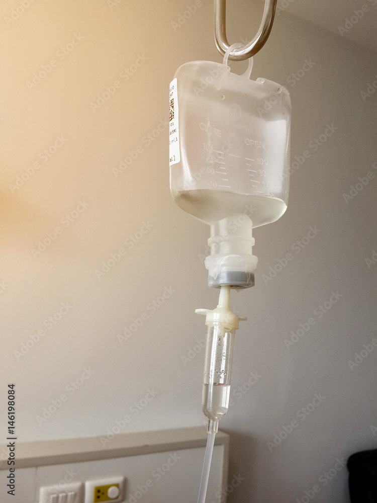 Infusion bottle with saline solution in Hospital, light effect. Infusion bottle with saline solution in Hospital, light effect.