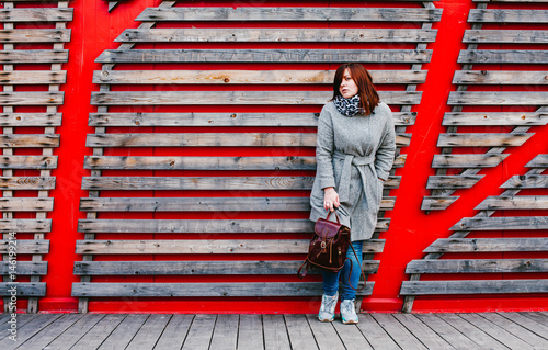 Girl in coat and with a backpack on the street