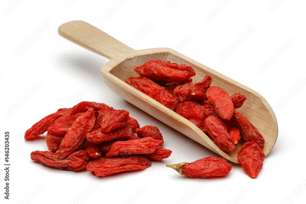 Dried goji berries in wooden scoop Dried goji berries in wooden scoop