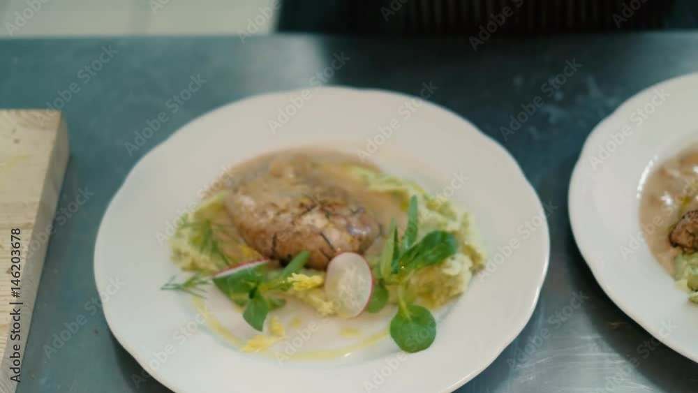 The cook in the restaurant prepares and serves an appetizing dish 4k The cook in the restaurant prepares and serves an appetizing dish 4k