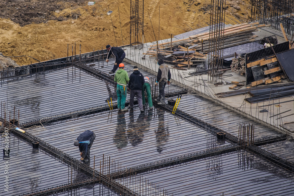 workers working at a construction site workers working at a construction site