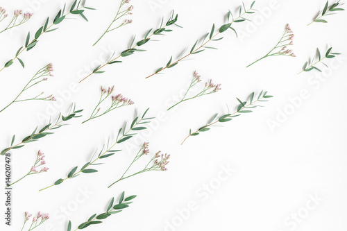 Flowers composition. Pattern made of pink flowers and eucalyptus branches on white background. Flat lay  top view