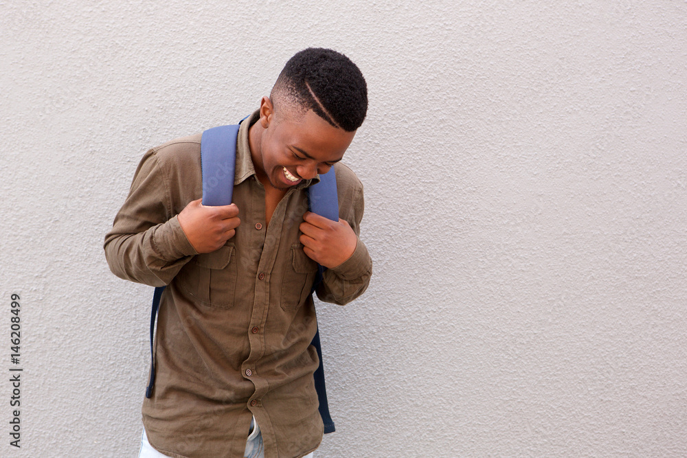happy black male student laughing with bag happy black male student laughing with bag