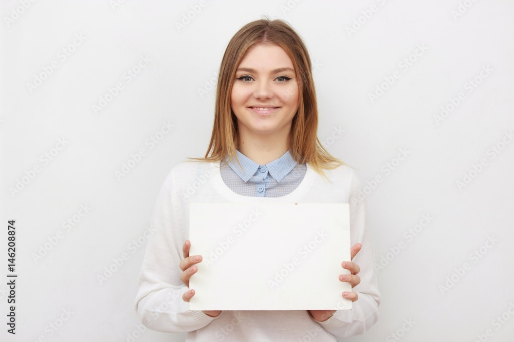 Young smiling woman show blank card or paper Young smiling woman show blank card or paper