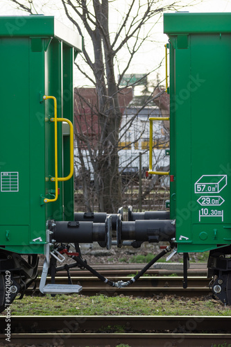 Burgas, Bulgaria - March 20, 2017 - Freight cargo train Buffer- 4axled box wagon green Type:Eanos Model:155-1 - Transvagon AD photo