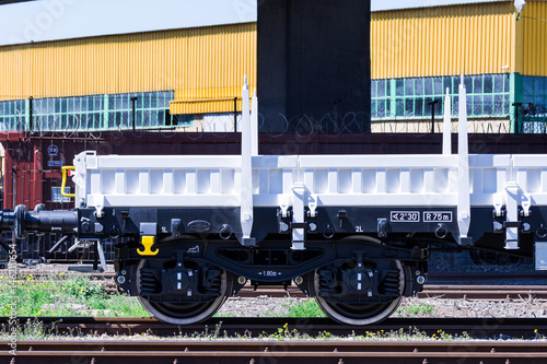 Burgas, Bulgaria - March 20, 2017 - Freight cargo train Wheels - 4axled flat wagon white Type:Rens Model:192, B - Transvagon AD