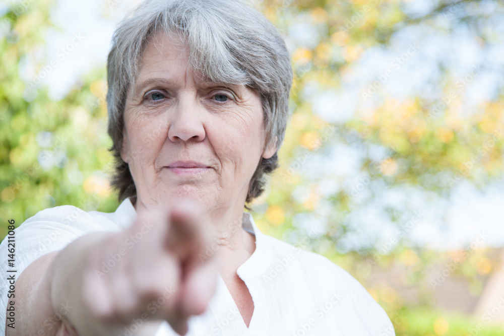 Senior woman pointing with finger Senior woman pointing with finger